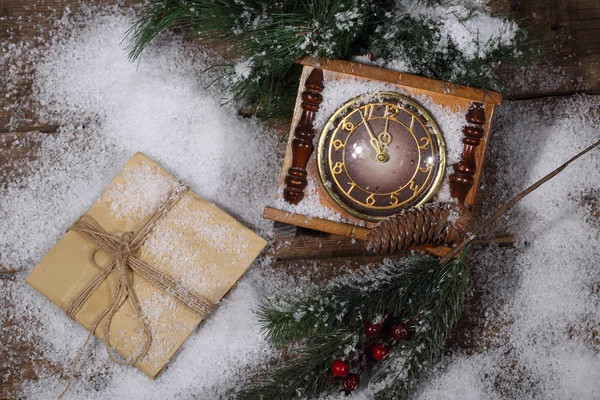 New Year's hours on snow with a fur-tree branch — Stock Photo, Image